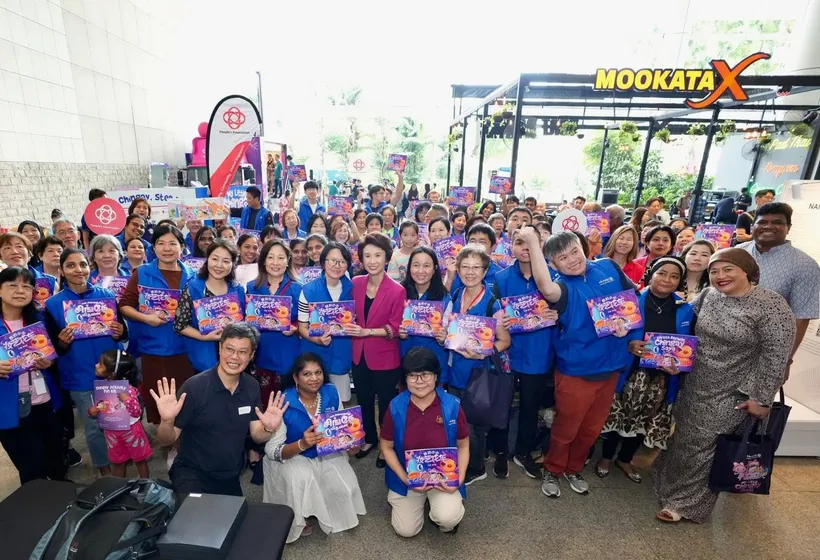 Chingay volunteers and community participants holding activity books
